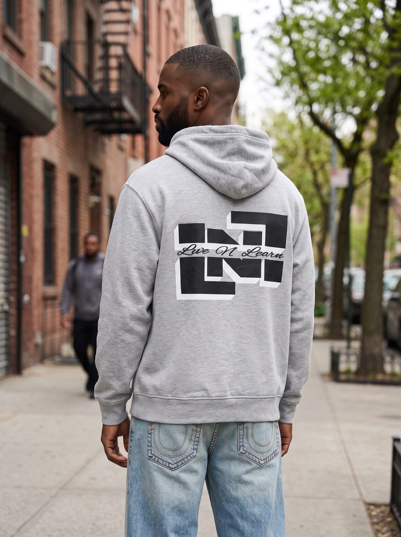 ELENELE hoodie photographed from behind on a city sidewalk